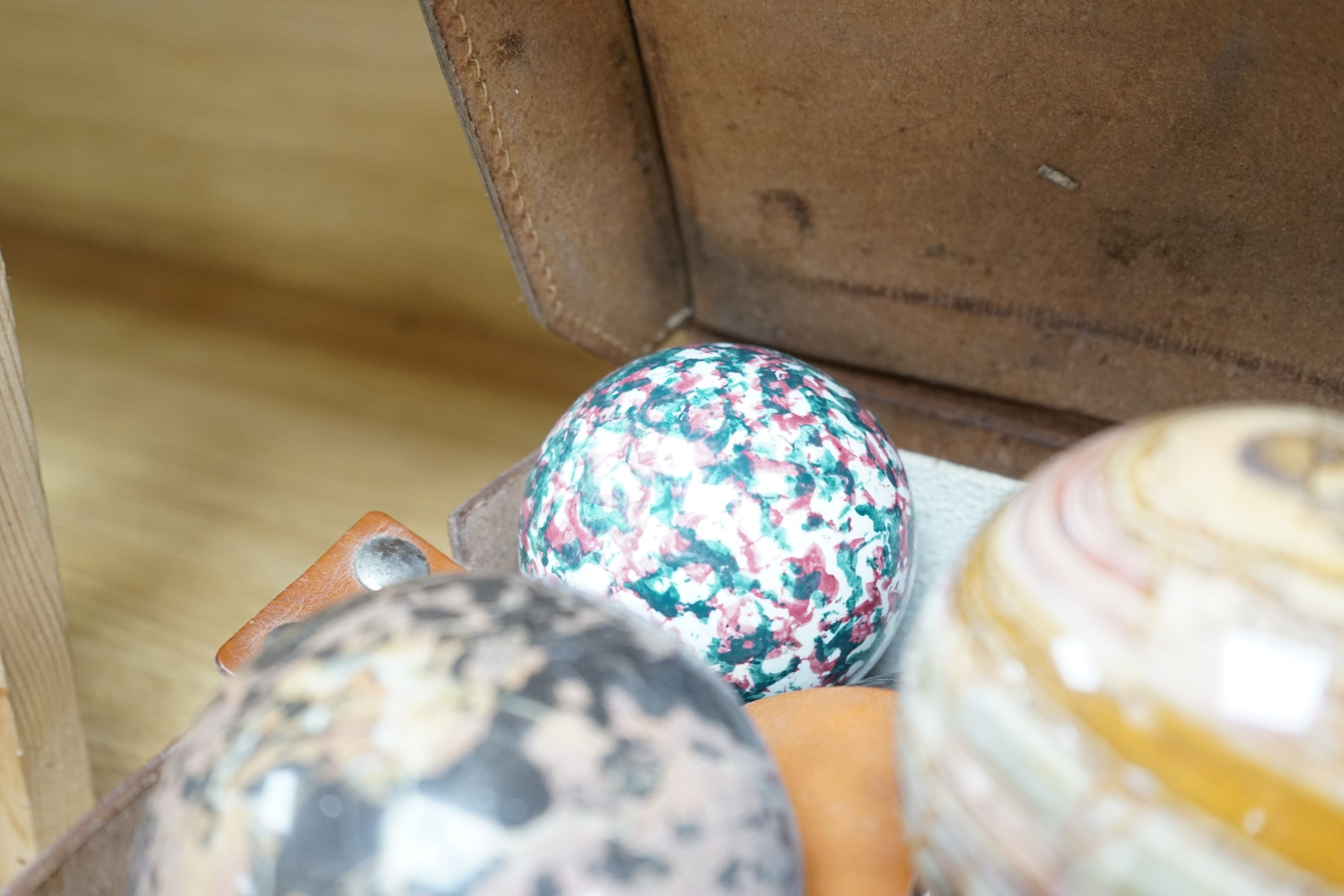 A collection of polished semi-precious stone eggs and balls